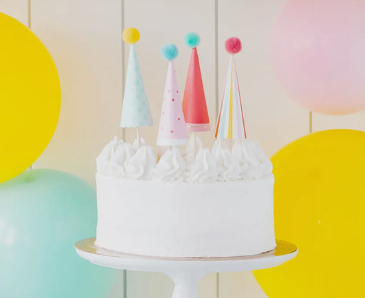 set of four party hat shaped cake toppers